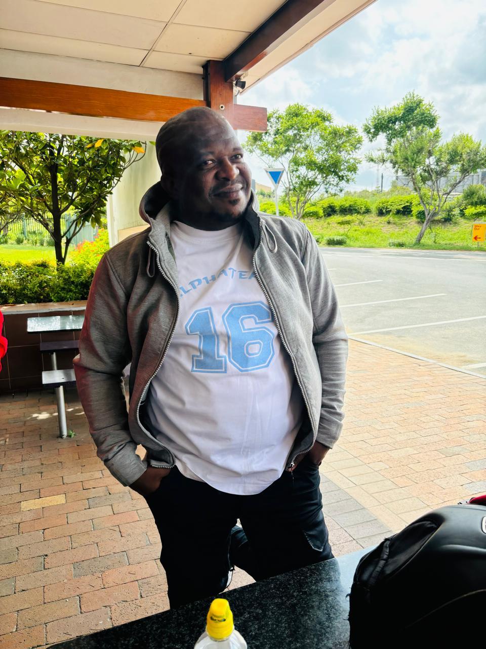 Alpha Team member in a number 16 club shirt at a rest stop